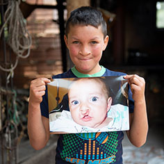 Photo of a boy holding up his photo. Link to Life Stage Gift Planner Over Age 70 Situations. Photo of a boy holding up his photo. Link to Life Stage Gift Planner Over Age 70 Situations.