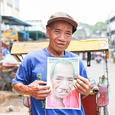 A man holding up a photo. Read about Gifts That Pay You Income A man holding up a photo. Read about Gifts That Pay You Income