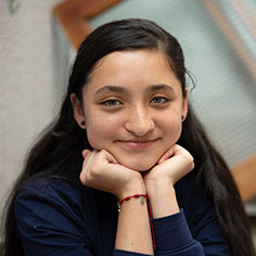 A girl smiling. Read about Gifts of Real Estate A girl smiling. Read about Gifts of Real Estate