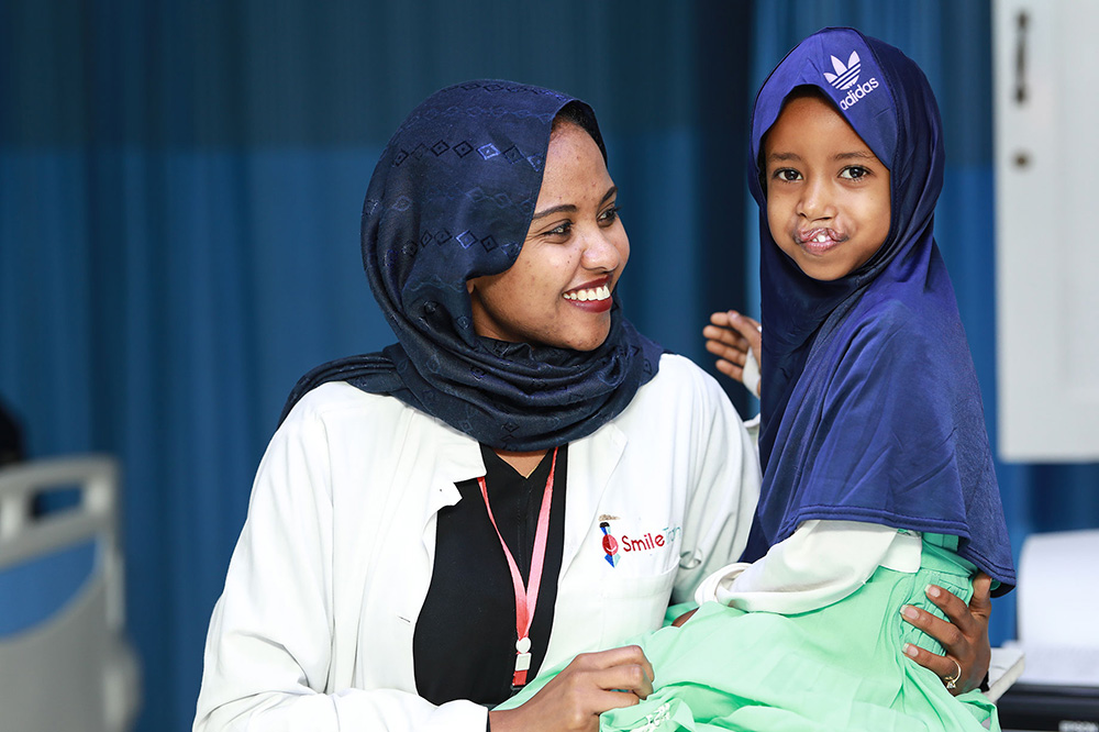 A woman and child smiling.